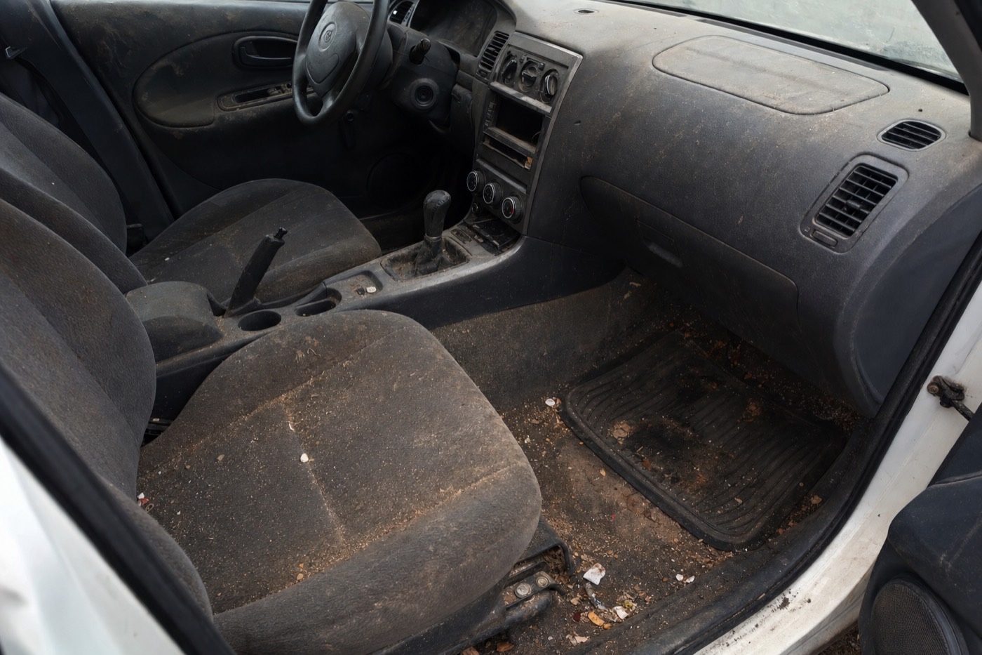 Sample image: vehicle interior with crumbs and grime before detailing